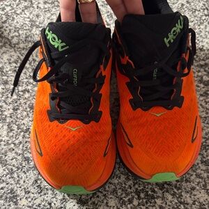 Hoka Vibrant Orange and Black Athletic Shoes